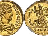 a gold coin with an image of a woman on it