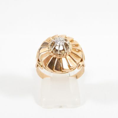 a close up of a gold ring with a diamond in the center