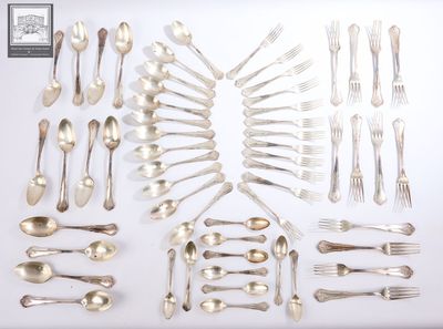 a lot of silverware on a white table