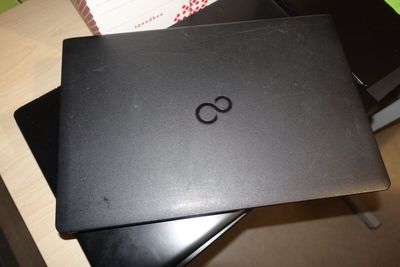 a black laptop sitting on top of a black chair