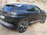 a black car parked on the side of a dirt road