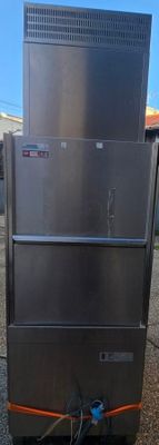 stainless steel refrigerators stacked on top of each other in a parking lot