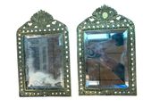 two mirrors on the wall with a person taking a picture