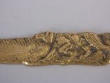 a gold plate with a picture of a dog on it