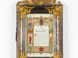 an ornate gold frame with a picture of a man and a woman