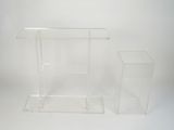 two clear acrylic stands on a white surface with a white background