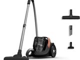 black and silver vacuum cleaner and accessories on a white surface