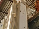 several pieces of wood are stacked on top of each other in a warehouse