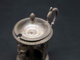 an antique silver teapot on a black background with a black background