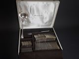 a box with silverware in it on a black surface