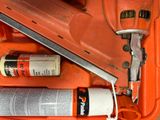 an orange tool box with a stapler, glue gun, and a can of glue