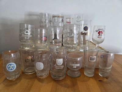 a lot of glasses sitting on a wooden table