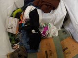 a pile of clothes and other items on a bed