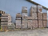 a large pile of bricks sitting outside of a building