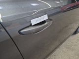 a car door handle with a sticker on it