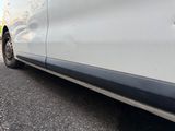 a white van that is parked on the side of the road
