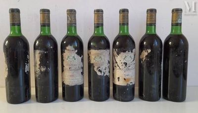 six bottles of wine are lined up in a row on a table