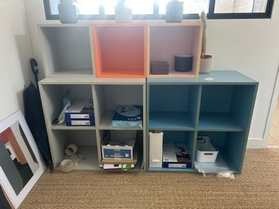a room with a shelf and a picture on the wall