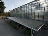a large glass building that has a bench in front of it