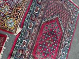 several oriental rugs are laid out on the floor in a room