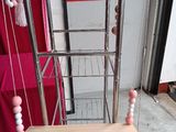 a bird cage with a ladder and a table with beads on it