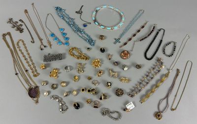 a lot of necklaces and bracelets on a table