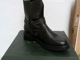 a black boot that is on top of a box