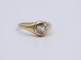 a close up of a gold ring with a diamond on it