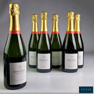 six bottles of champagne lined up in a row on a table