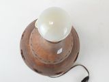 a light that is on top of a wooden lamp