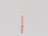 a gold necklace with a pink and white stone pendant on it