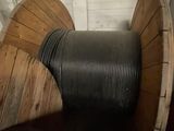 a wooden spool on the floor next to a wall