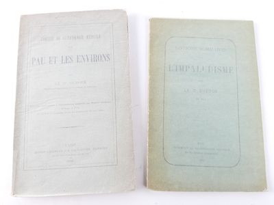 an old book sitting on top of a table next to another book
