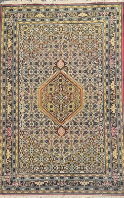 an antique persian rug with a medallion design on a red ground