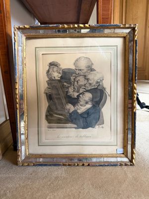 an old picture of a man holding a baby in a frame