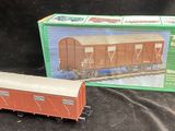 a toy train car and box on a black background