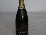 a bottle of champagne sitting on a marble table