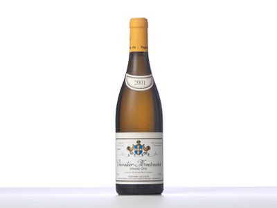 a bottle of white wine sitting on top of a table