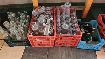 many empty glass bottles sitting in crates on the floor