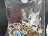 a bag of jewelry sitting on a table next to a cup of coffee