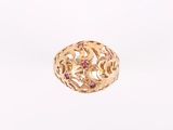a close up of a gold ring with pink stones on it