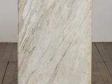 a white marble block sitting on top of a wooden floor