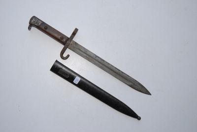 an old knife and a small knife on a white surface