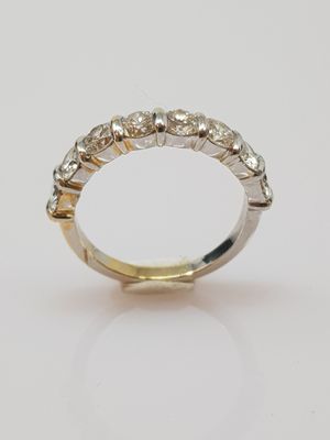 a white and yellow gold ring with five diamonds