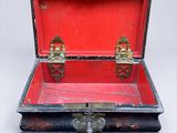 a red and black trunk with a lock on it