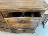 a wooden dresser with a drawer on top of it