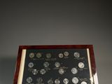 une vitrine en bois contenant plusieurs pièces de monnaie