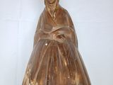 a statue of a woman that is sitting on a table