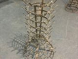 a metal sculpture of a bunch of spikes on the floor