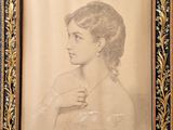 an old picture of a woman in a dress is shown in a gold frame